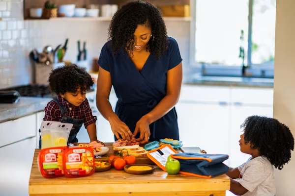 Busy mom organizing healthy meal prep containers in the kitchen